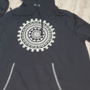 A black sweatshirt with a design on it